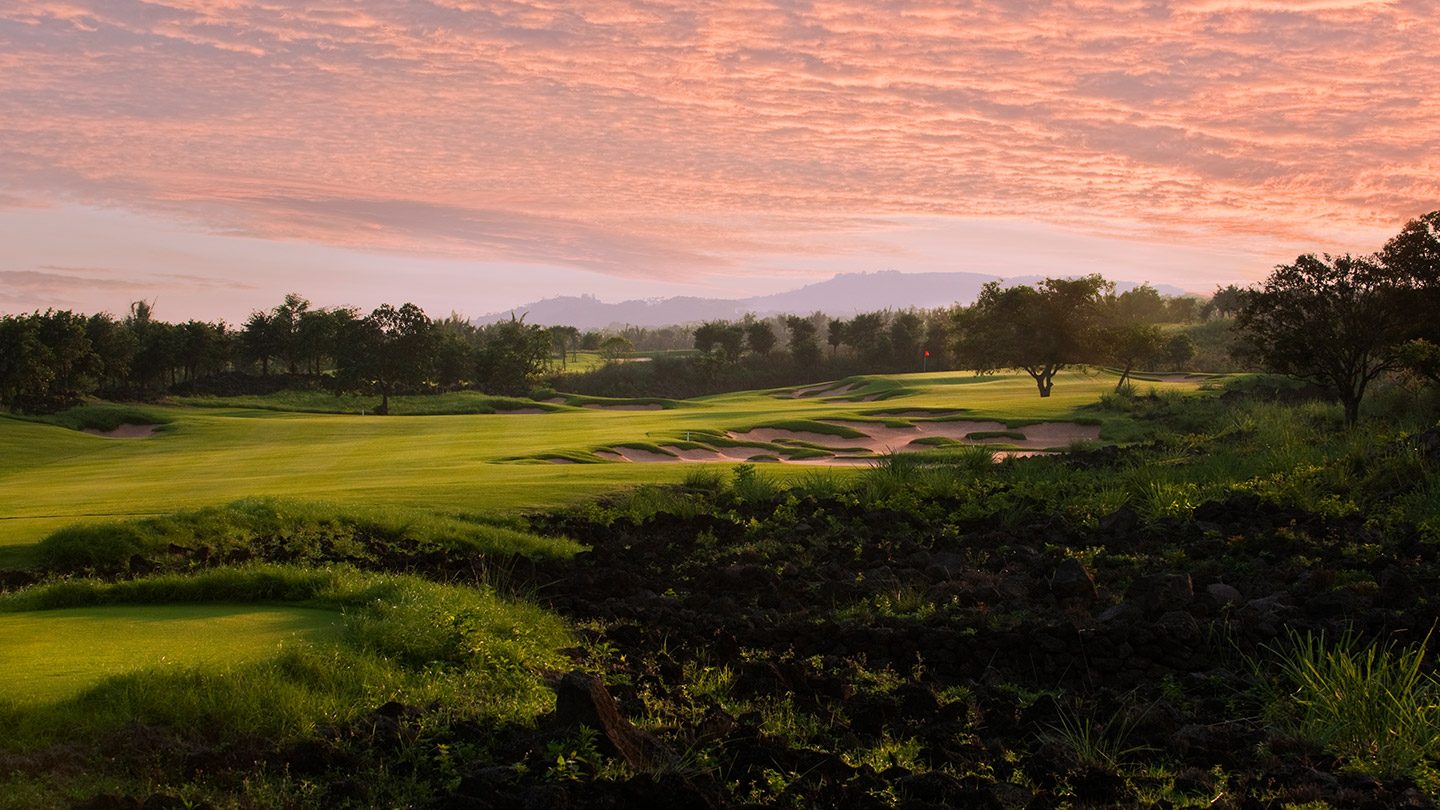 Dawn light over a Blackstone fairway, the sky turning pink above distant hills