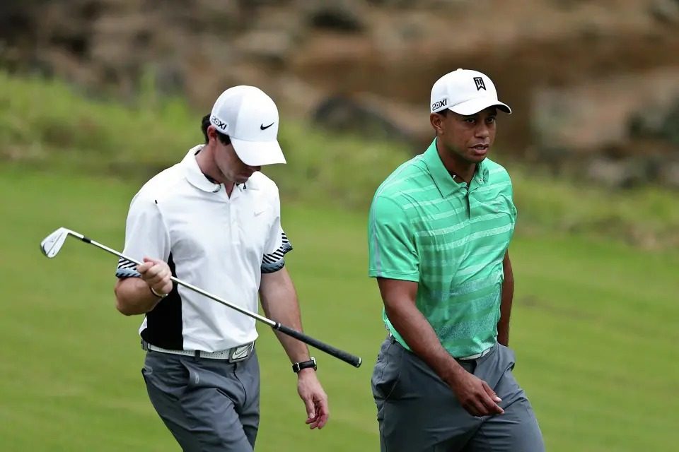 Tiger Woods and Rory McIlroy walking a fairway together during The Match at Mission Hills Haikou