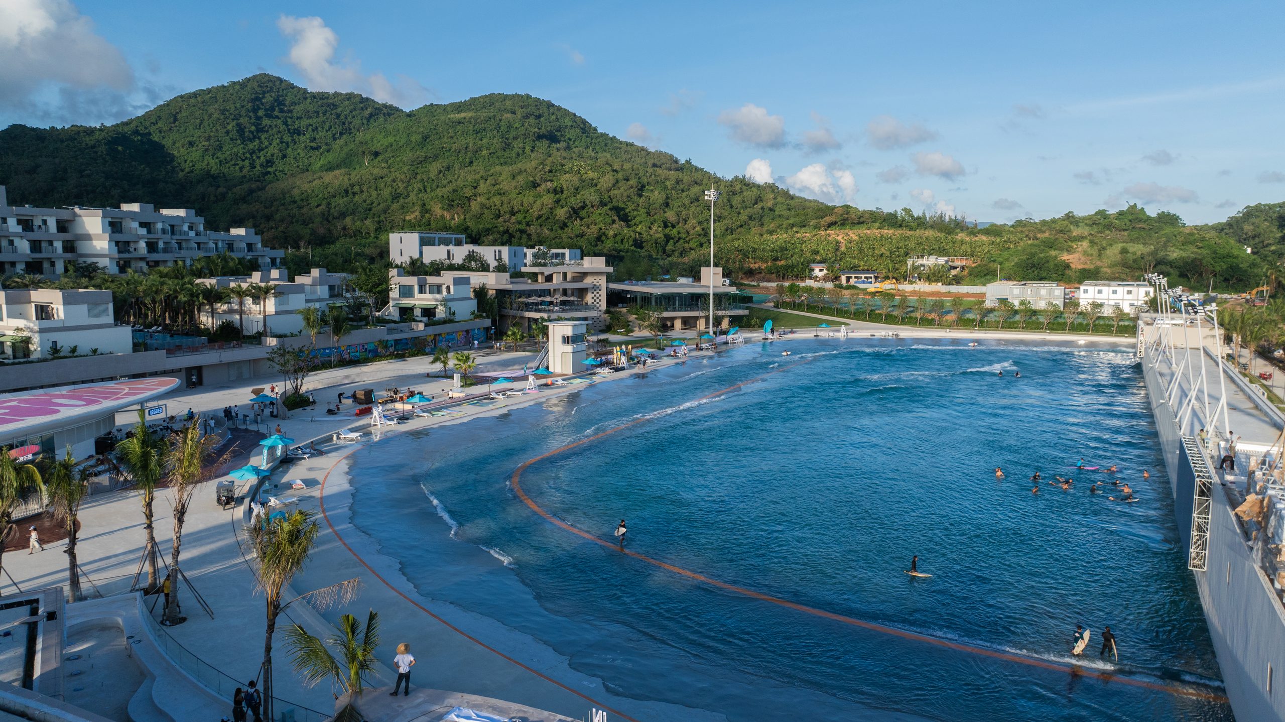 Surfers riding waves during a private PerfectSwell wave pool session at Riyue Bay, Hainan, China