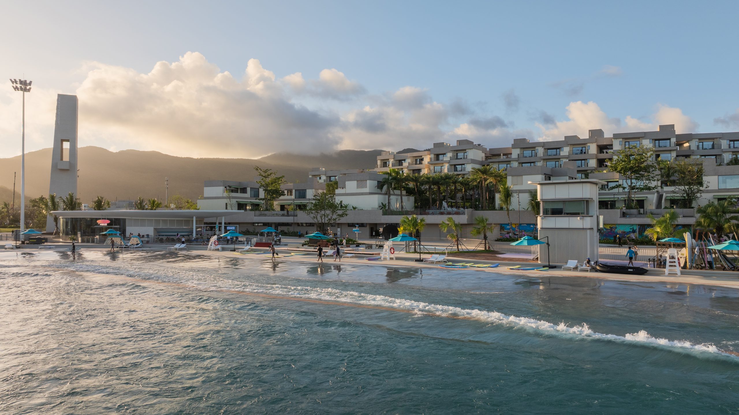 Group of surfers poolside at a private PerfectSwell wave pool session, Riyue Bay Surf Resort, Wanning, Hainan